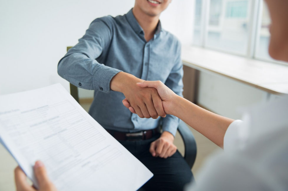 Smiling businessman shaking partners